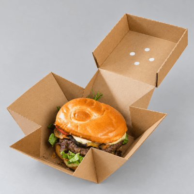 Open kraft burger box holding a fresh burger, with a folding lid and sturdy cardboard construction.